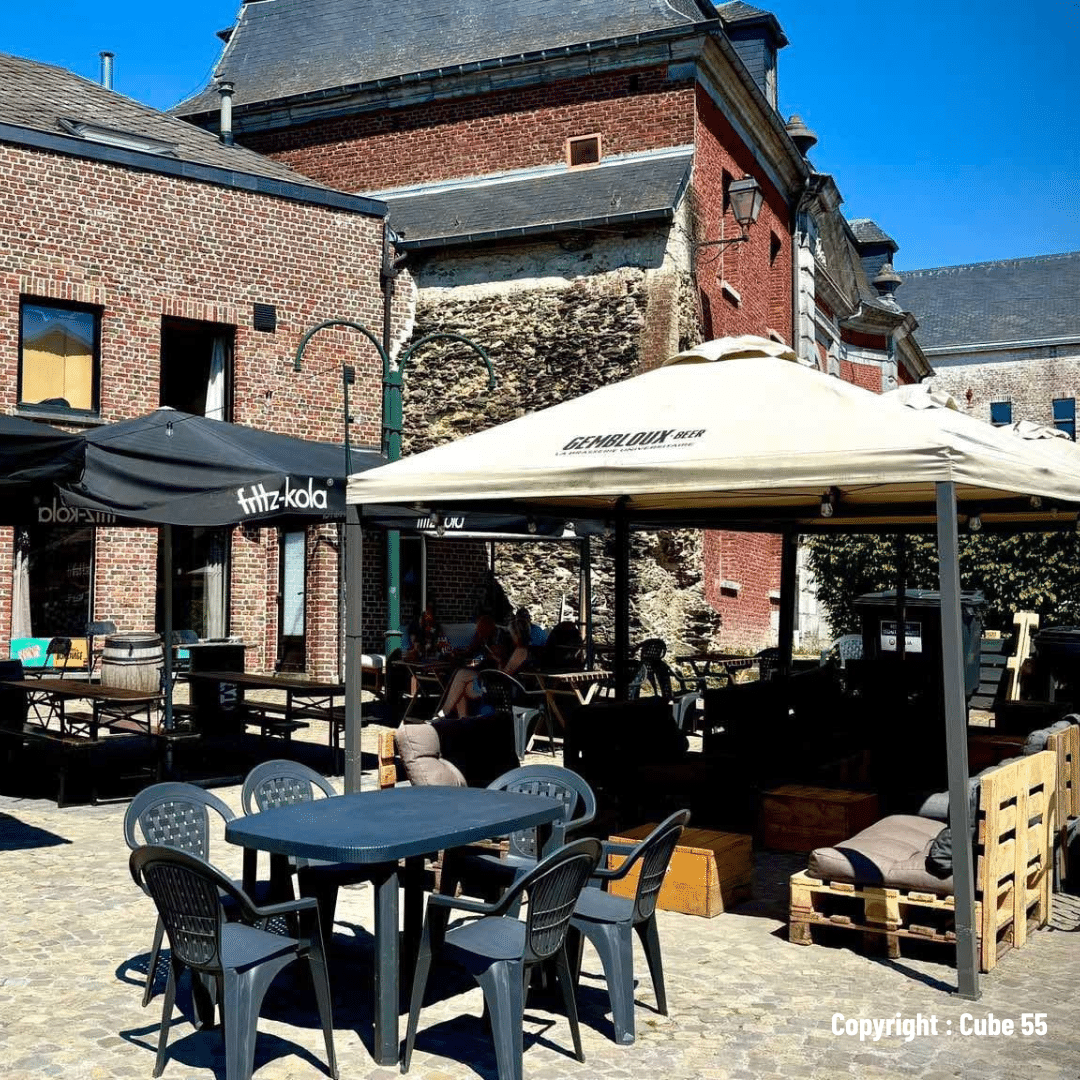 se restaurer à Gembloux Place Saint Jean à Gembloux en été, sous un ciel bleu éclatant, offrant une ambiance animée et chaleureuse, parfaite pour profiter de la ville ensoleillée.